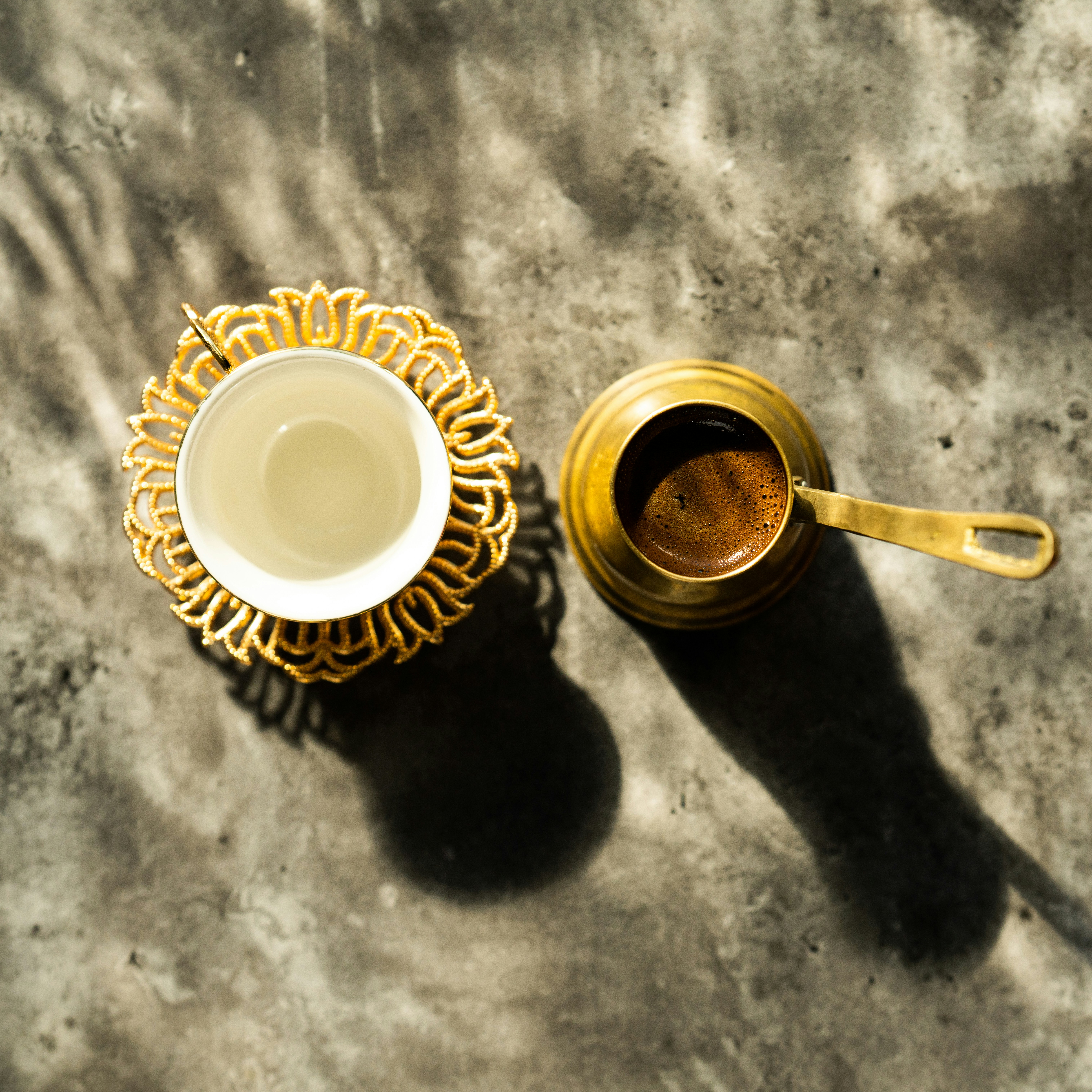 a cup of coffee and a spoon on a table