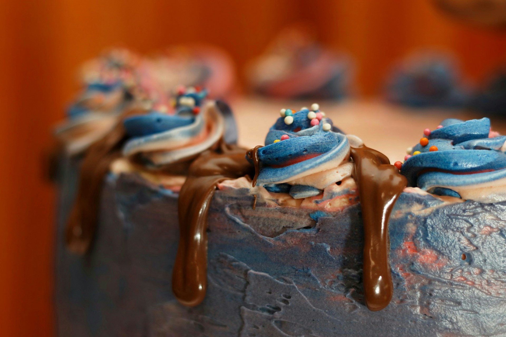 a close up of a cake with frosting and sprinkles