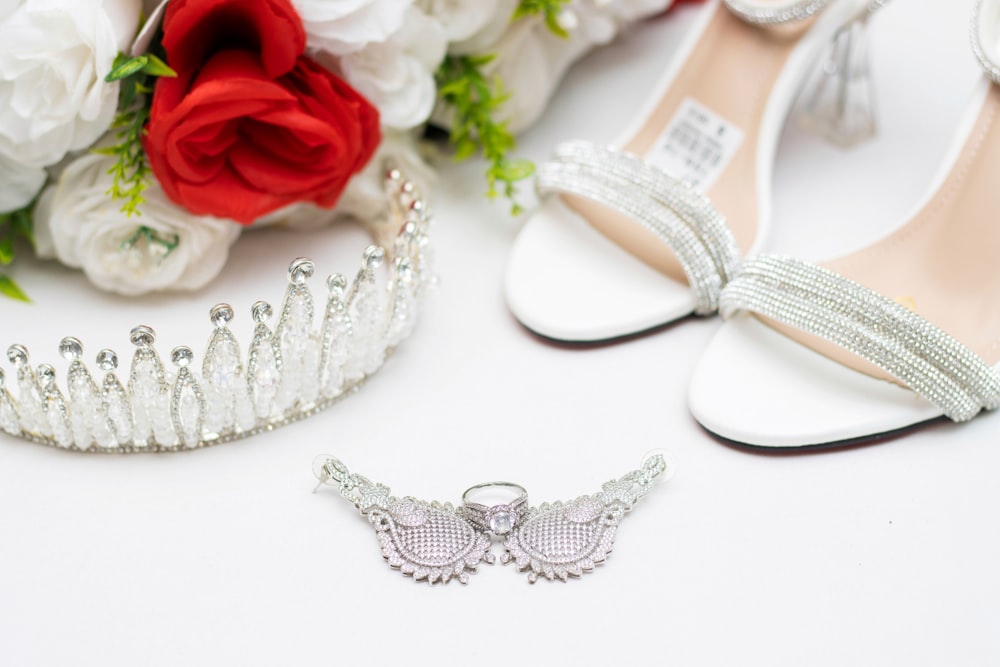 a pair of shoes and a tiara on a table