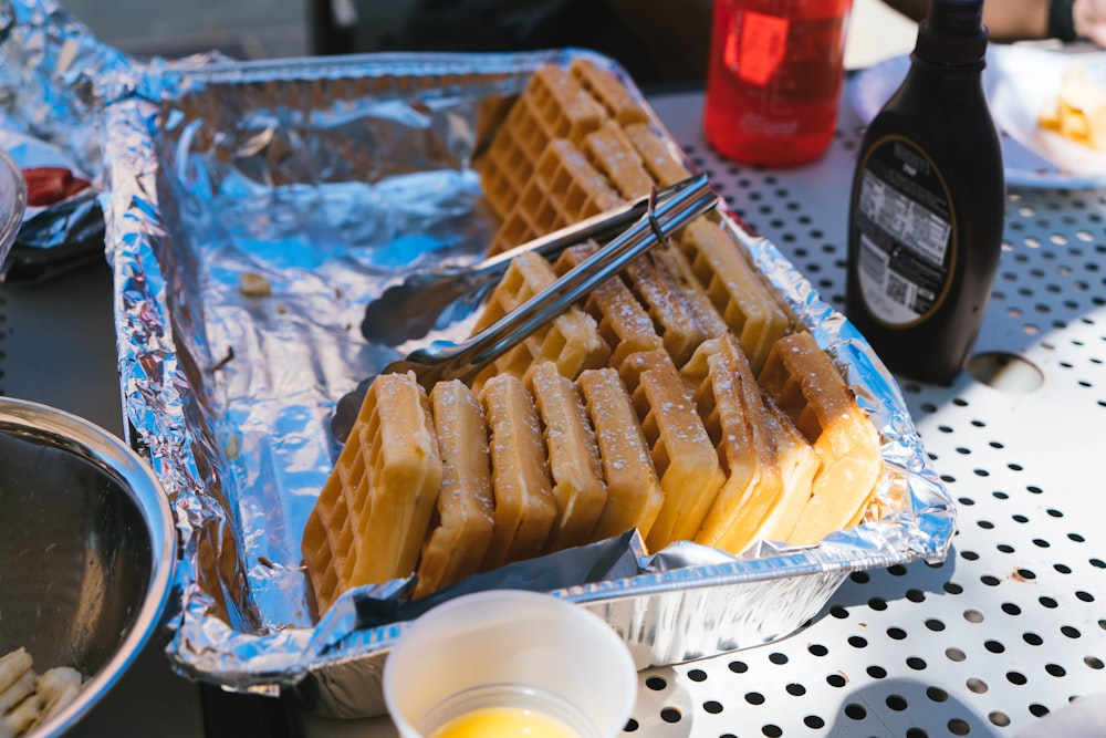 a pan filled with waffles sitting on top of a table