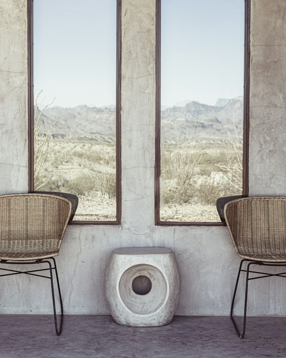 a couple of chairs sitting next to a window