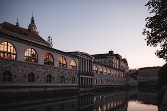 a large building sitting next to a body of water