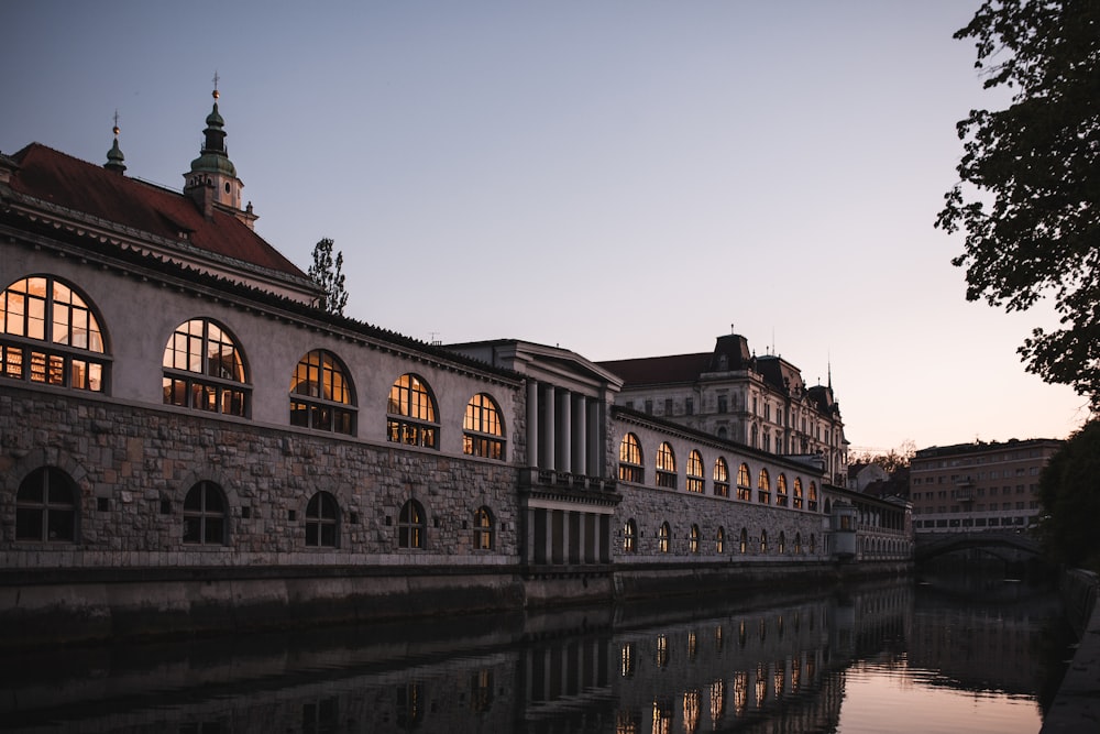 a large building sitting next to a body of water