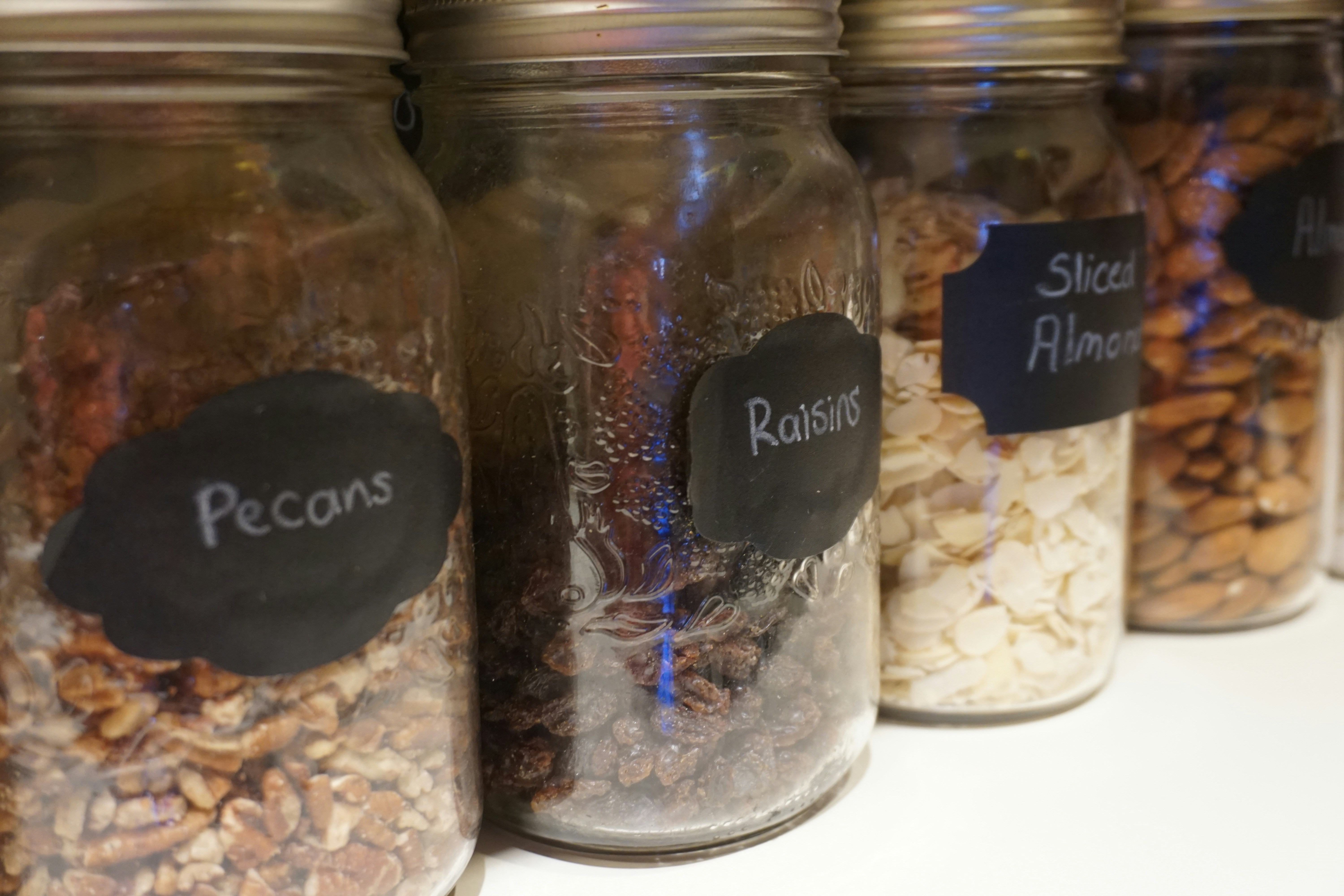 a row of jars filled with different types of food
