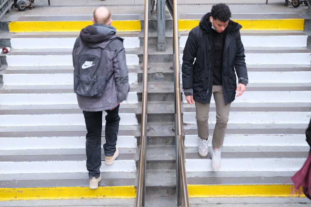 two people walking up a set of stairs