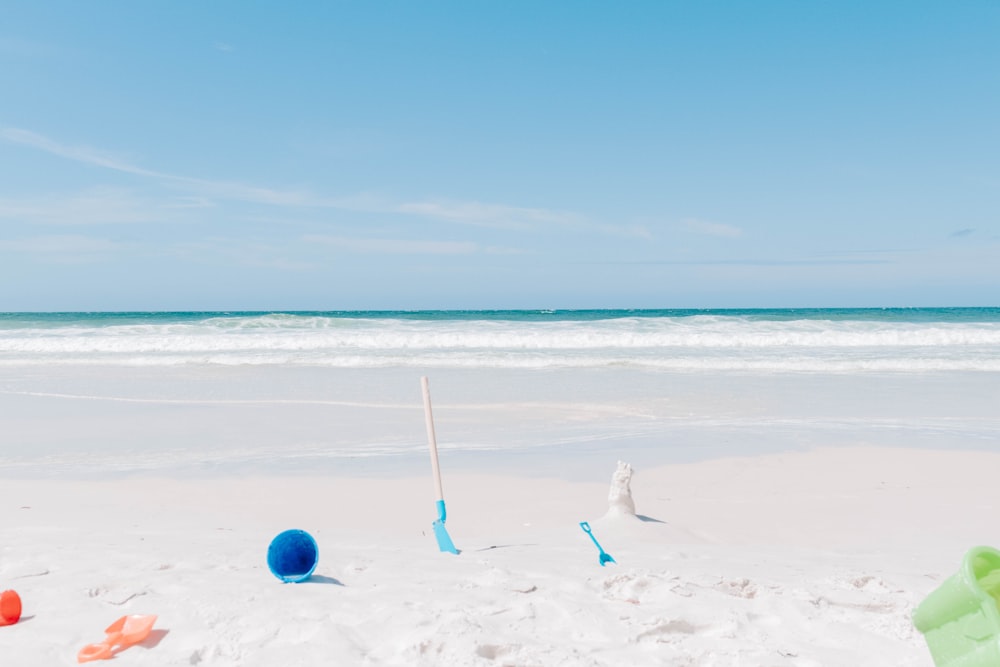 a beach with a bunch of toys in the sand