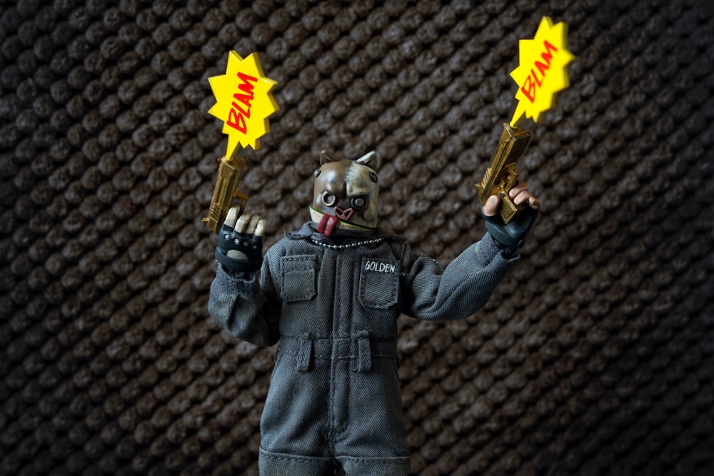 a toy figure holding two yellow stars in his hands