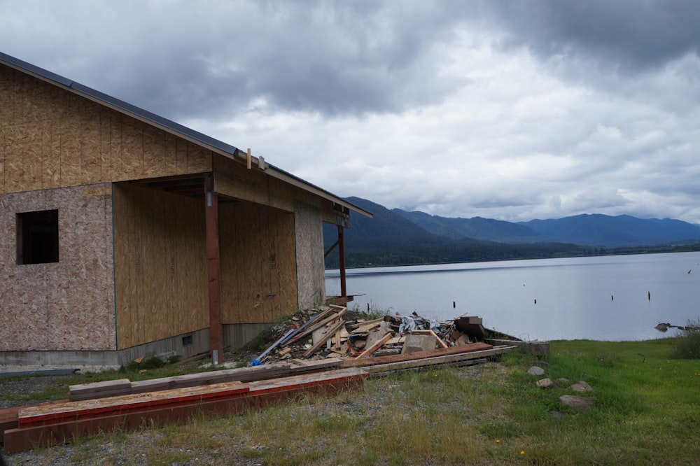 a house that is under construction next to a body of water