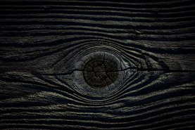 a close up of a wooden surface with a circular hole in the center