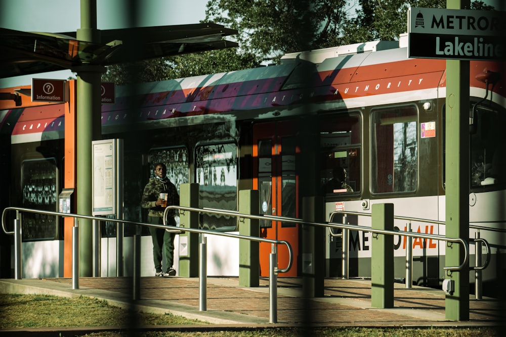 a man standing at the entrance of a metro station