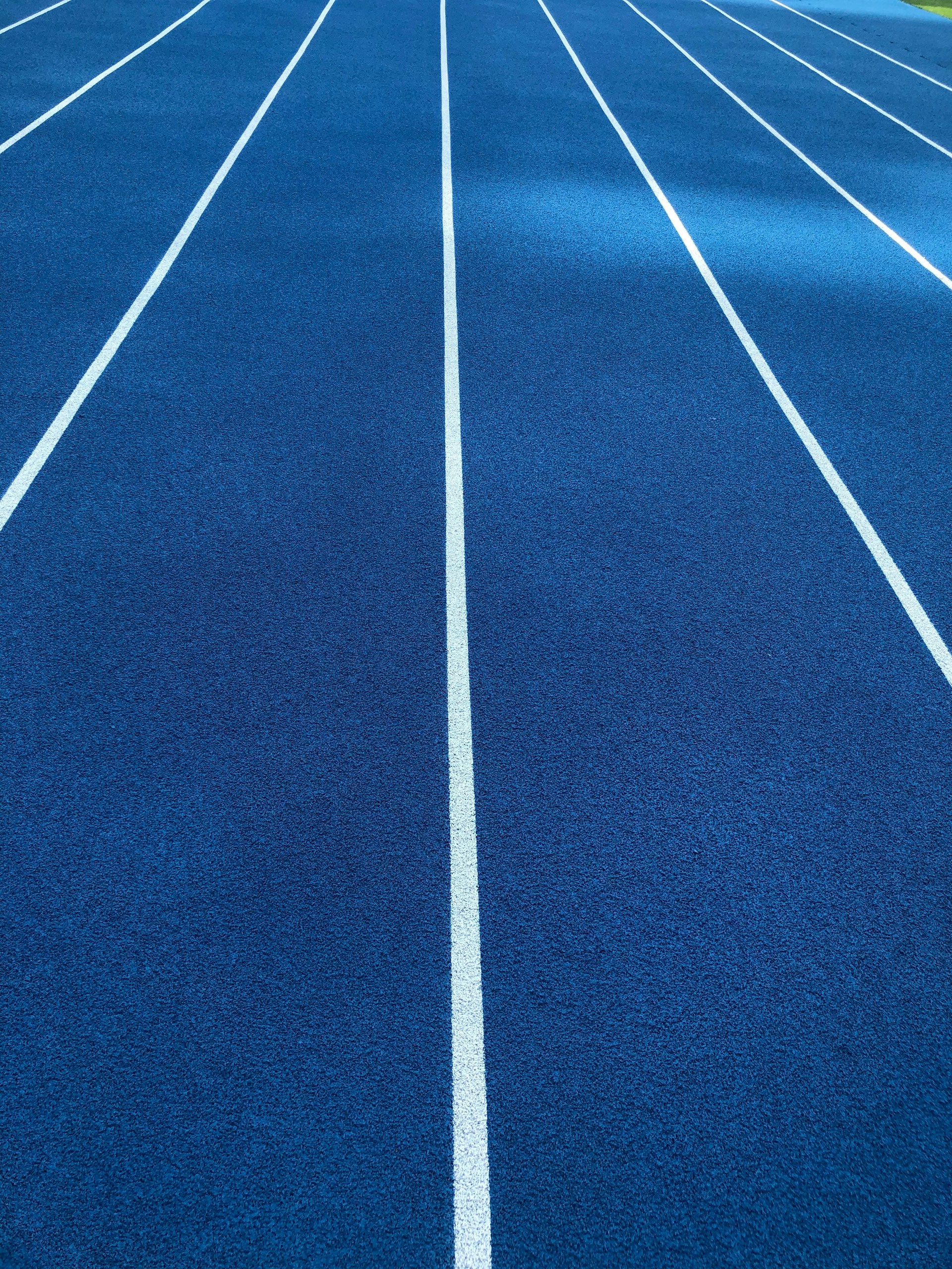 a blue running track with white lines on it