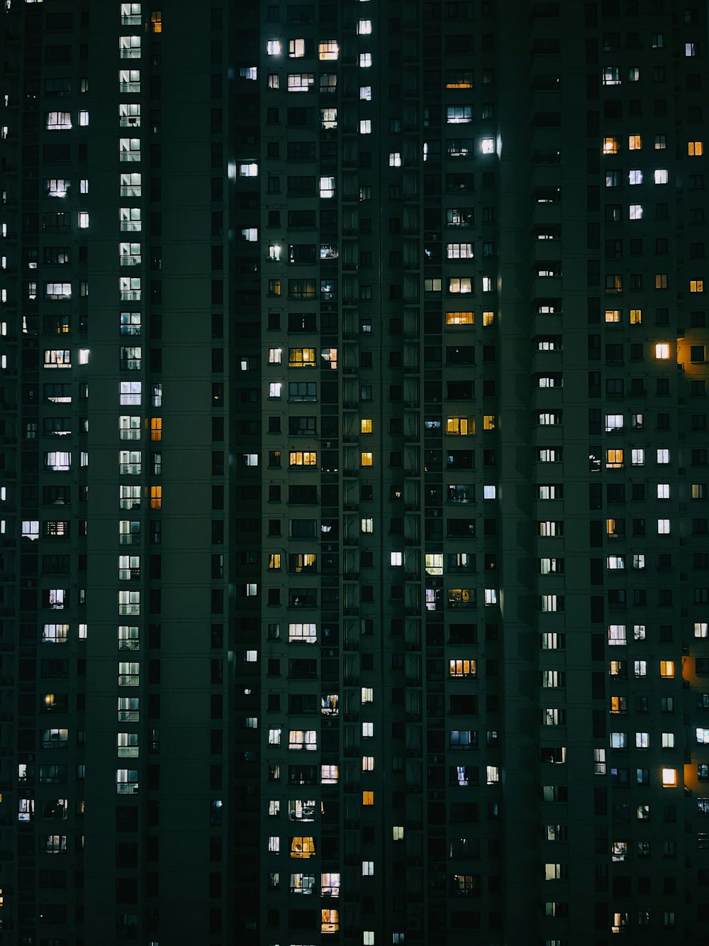 a very tall building with lots of windows at night