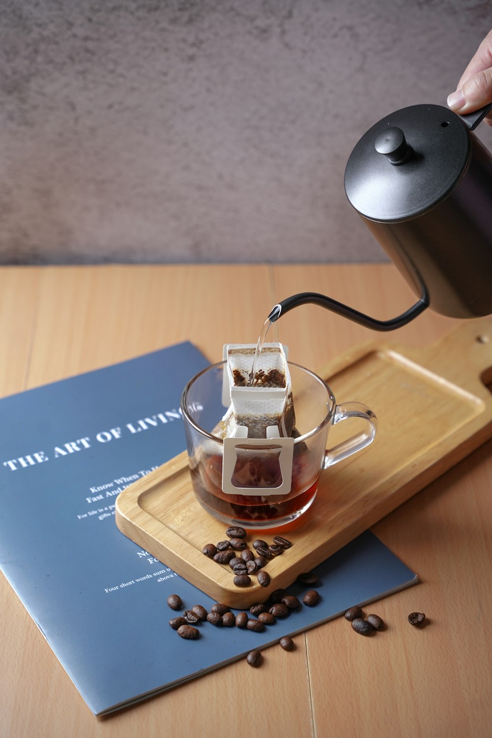 a person pouring coffee into a glass cup