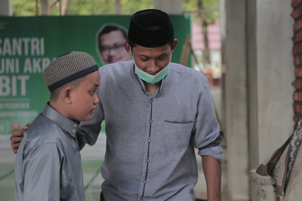 a man and a boy wearing a face mask