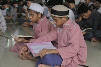 a group of young men sitting on the floor