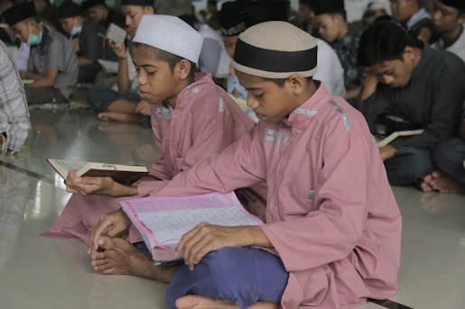 a group of young men sitting on the floor