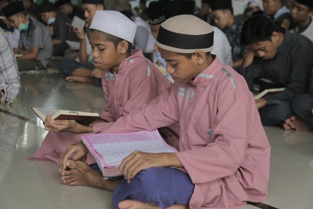 a group of young men sitting on the floor