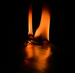 A glowing golden flame rising from a dark background symbolizing entrepreneurial spirit.