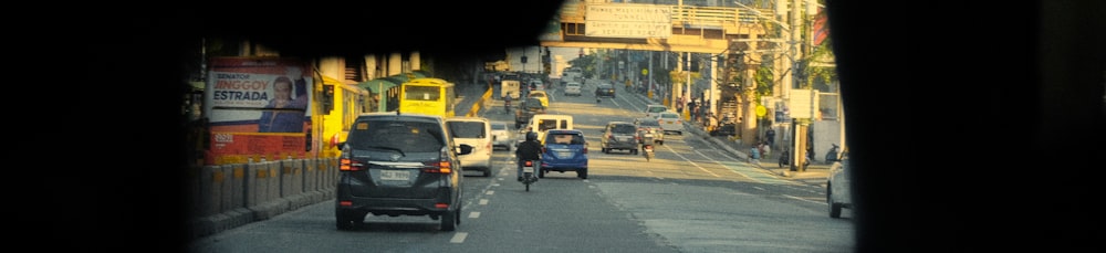 a car driving down a street next to tall buildings