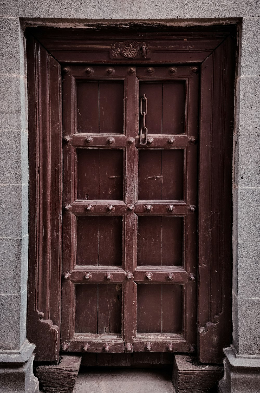 an old wooden door with iron bars on it