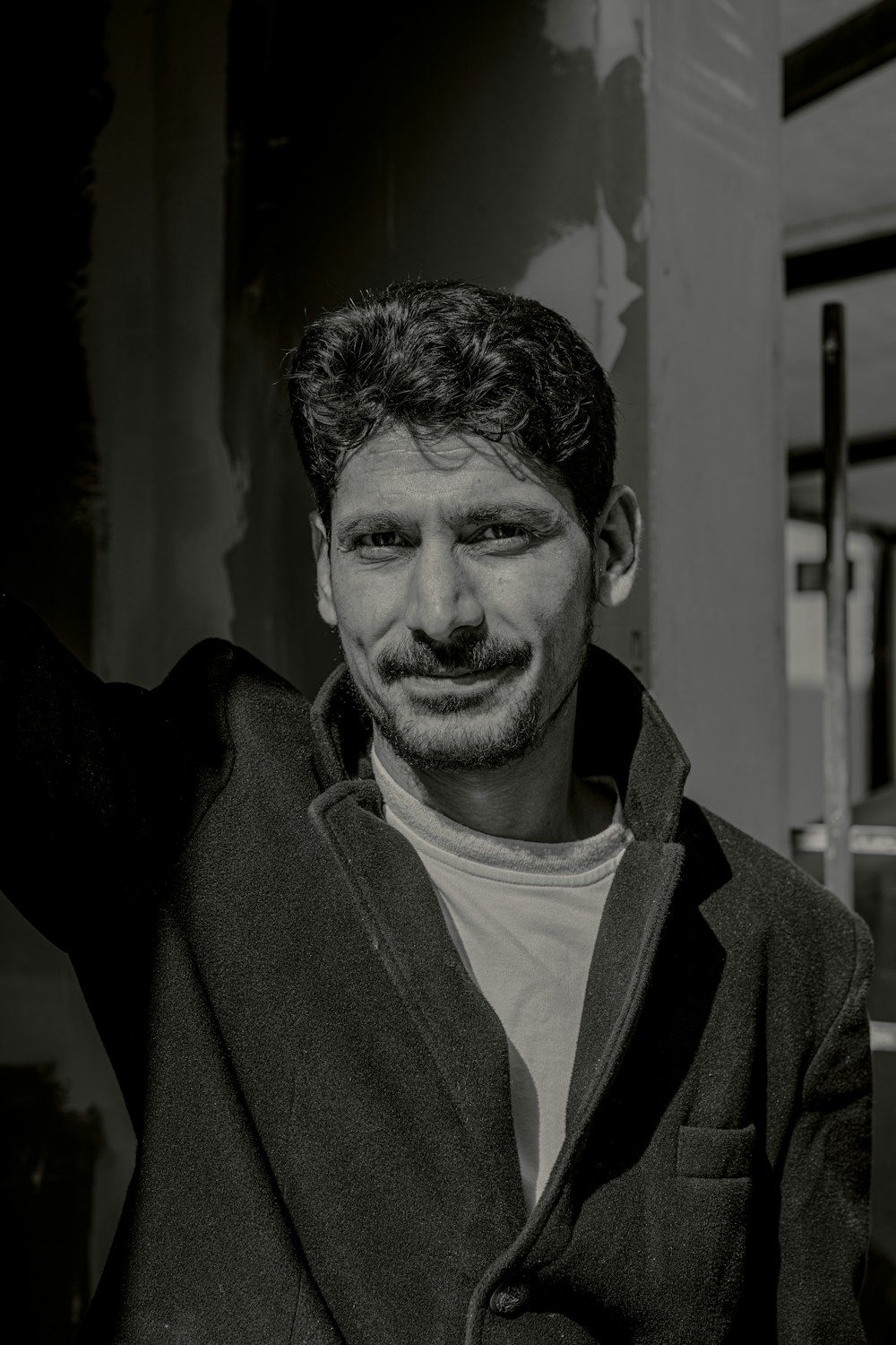 a black and white photo of a man smiling