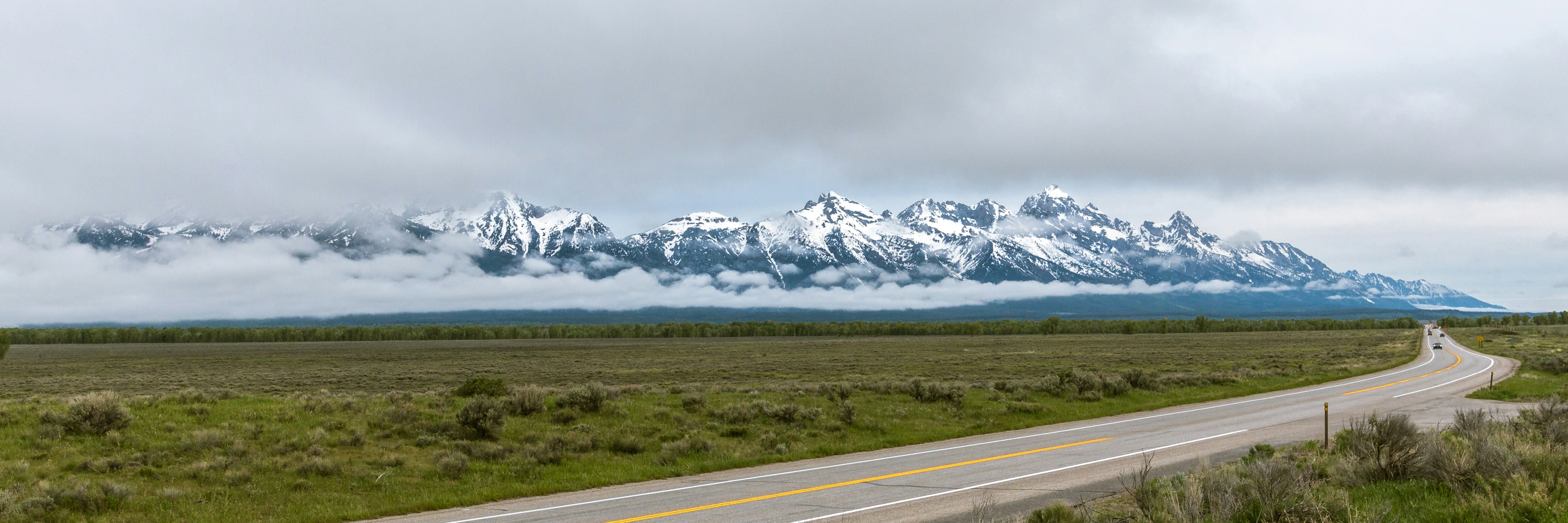 a long road with a mountain in the background