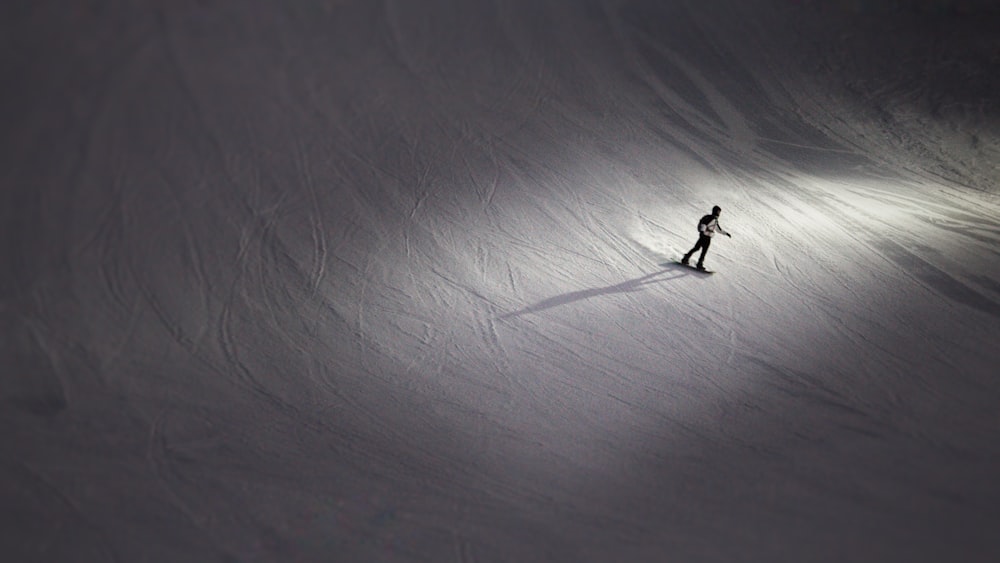 a person riding skis down a snow covered slope