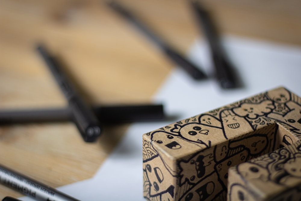 a couple of pens sitting on top of a wooden table