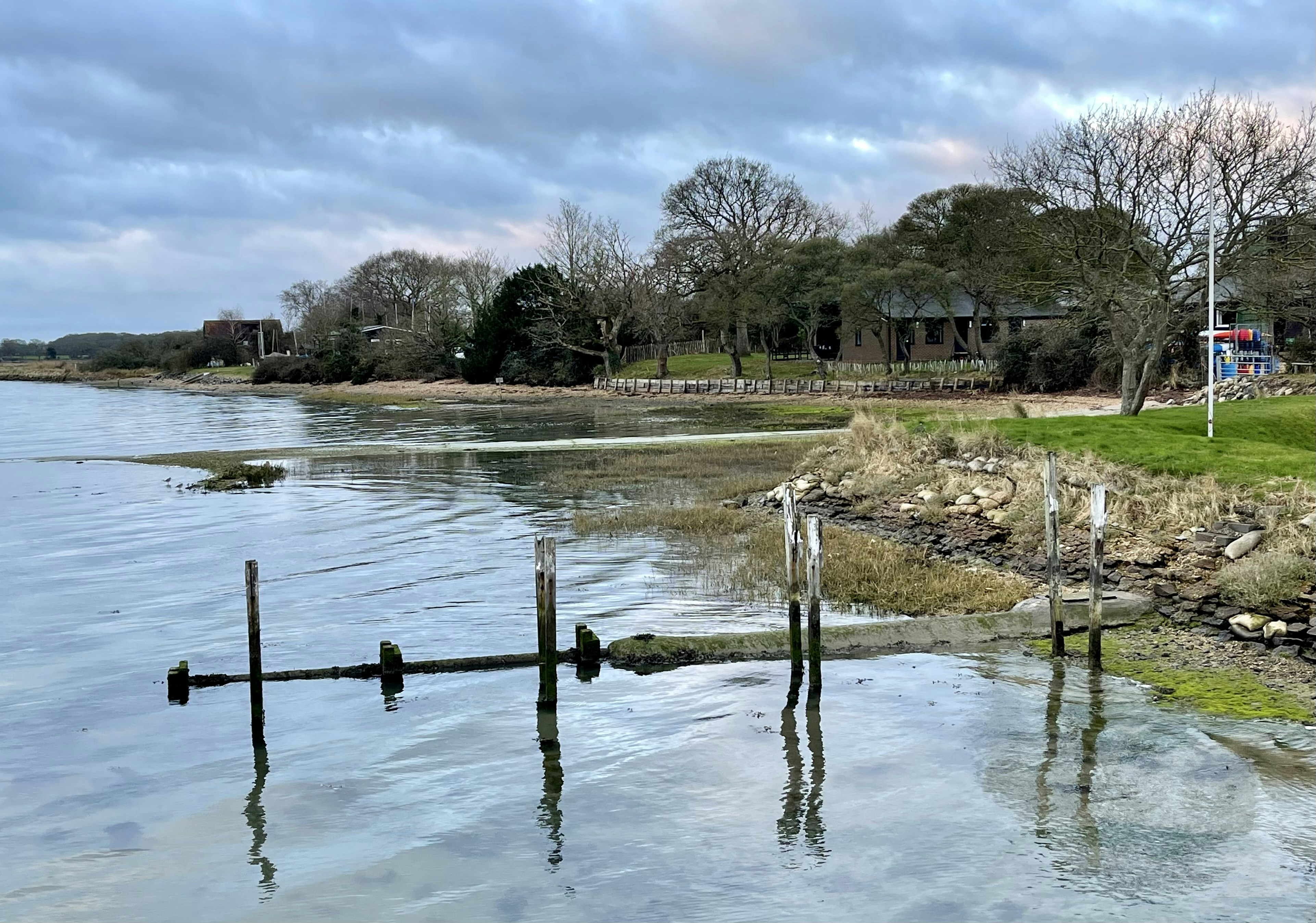 a body of water that has some poles sticking out of it