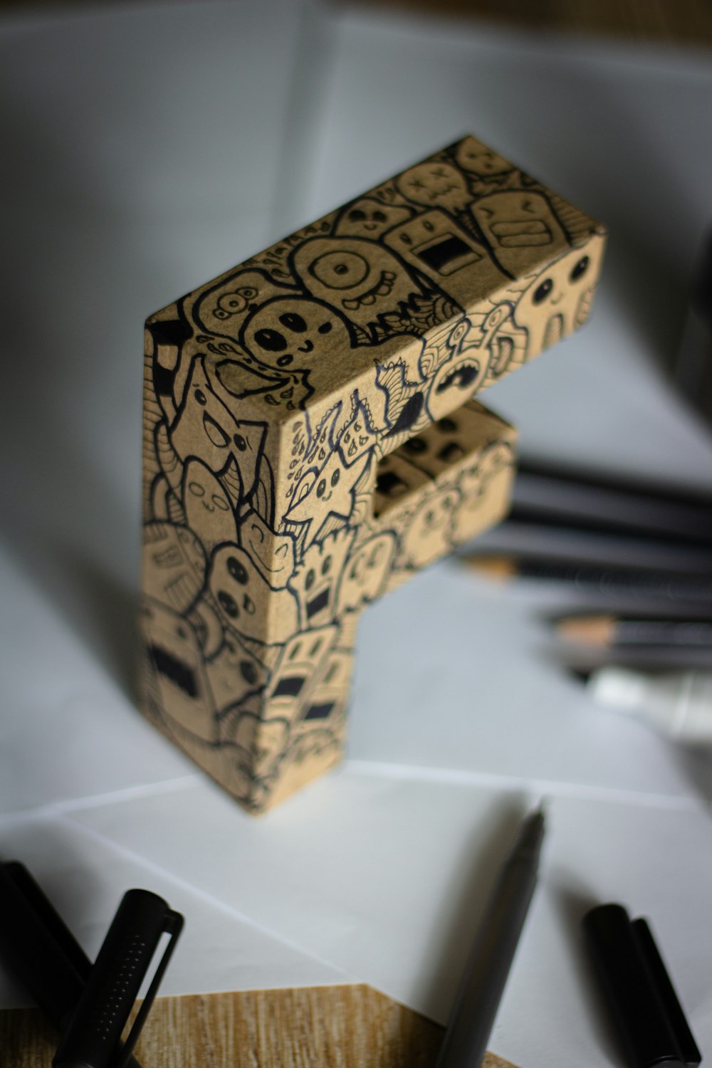 a wooden object with writing on it sitting on a table