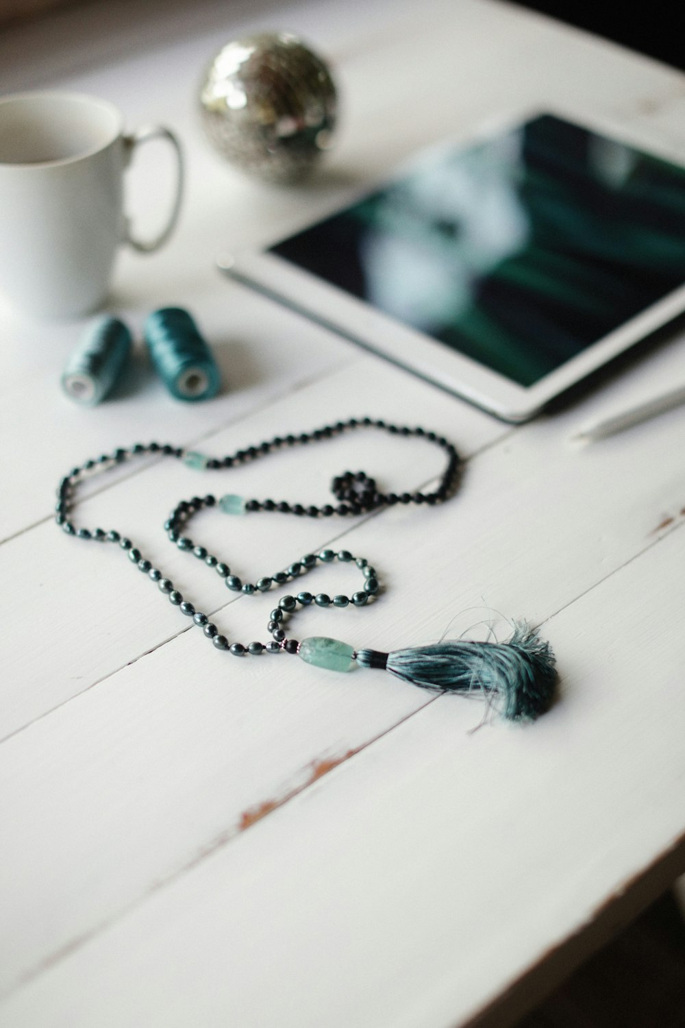 a table with a tablet and a tassel on it