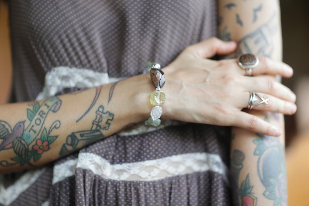 a woman with tattoos on her arm and arm