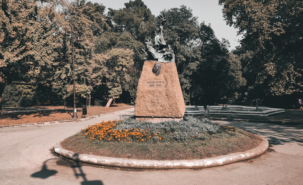 a statue of a man is in the middle of a park