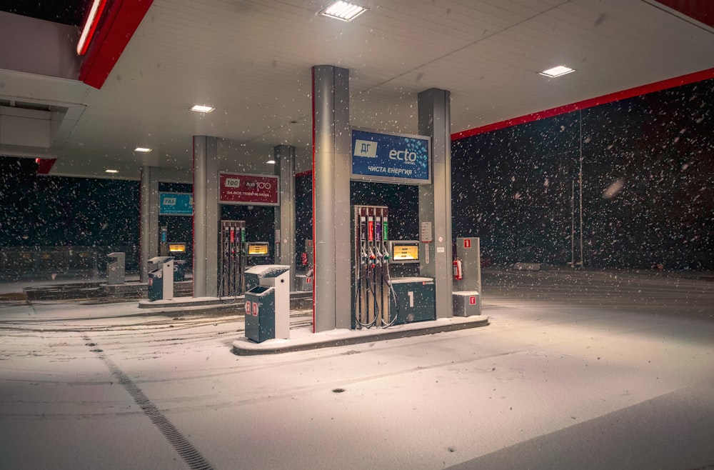 a gas station with snow falling on the ground