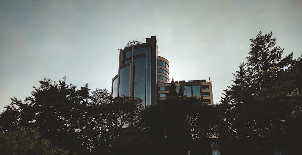 a tall building with trees in front of it