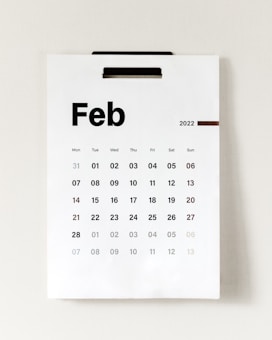 A wall calendar displays the month of February 2022. The days of the week are listed across the top, with individual dates arranged in a grid below. The overall design is simple and minimalistic.