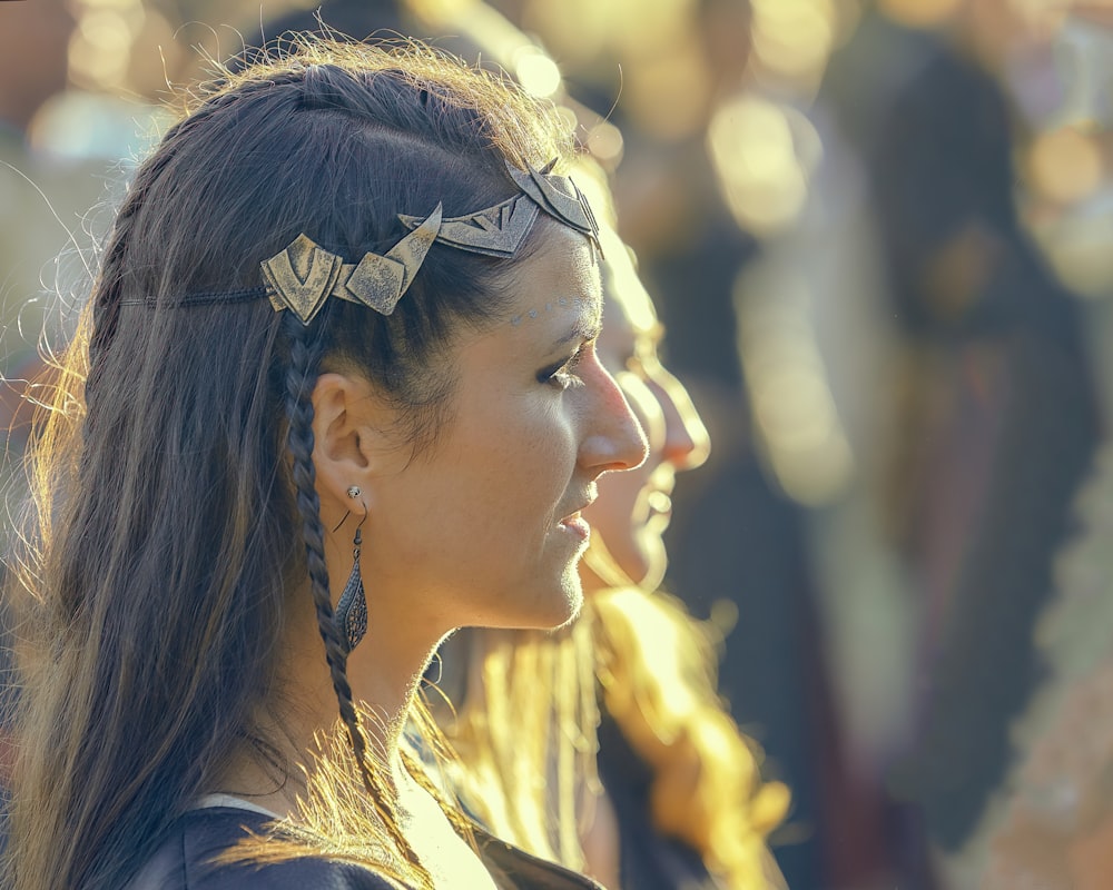 a woman with long hair wearing a pair of earrings