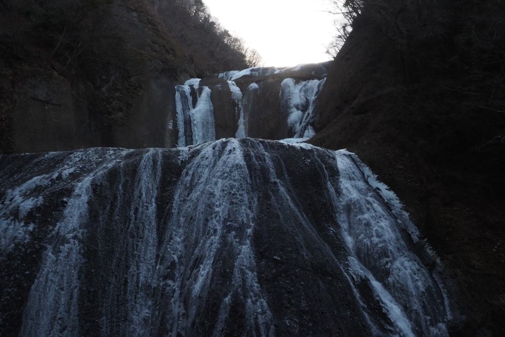 a very tall waterfall with lots of water coming out of it