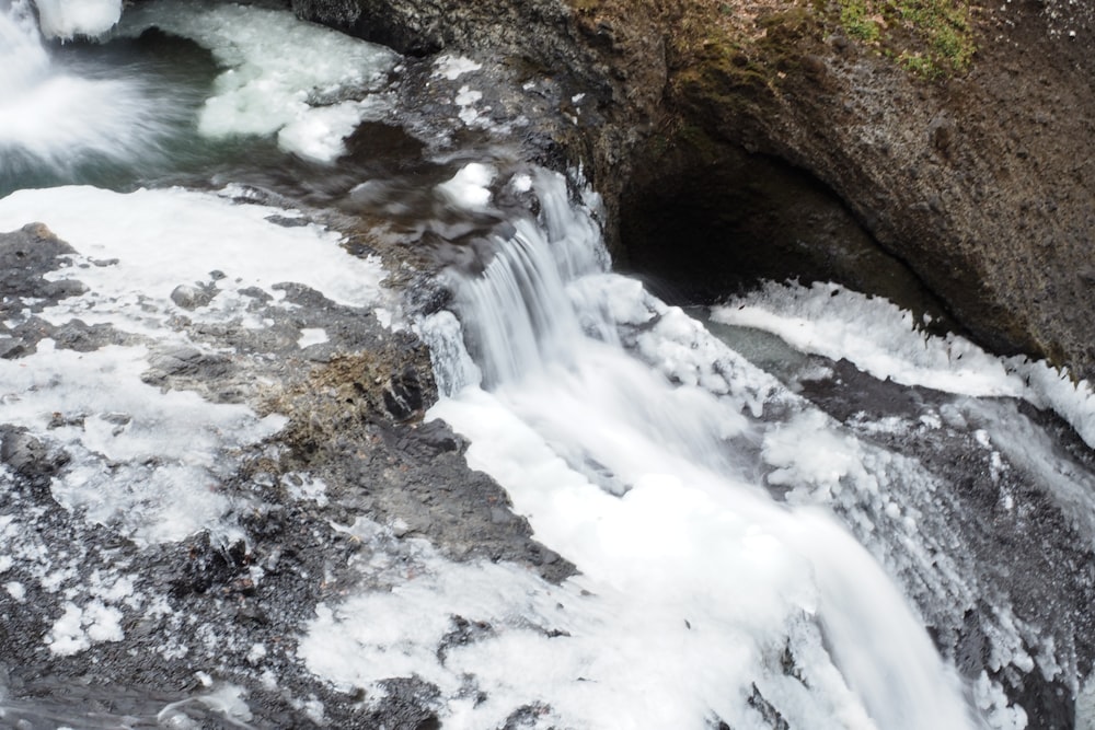 a stream of water running down a rocky cliff