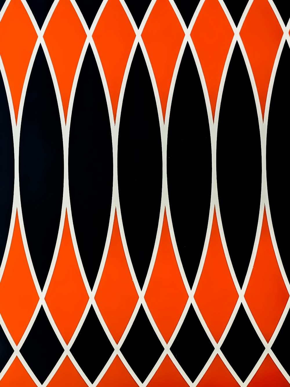 a black, orange and white wallpaper with circles