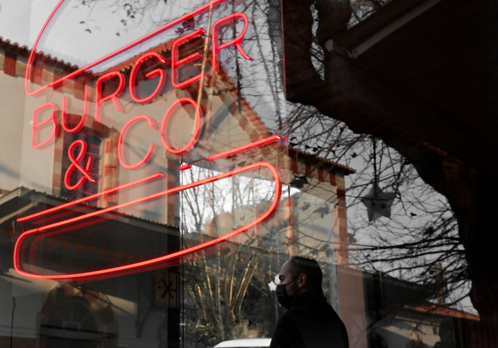 a man standing in front of a store window