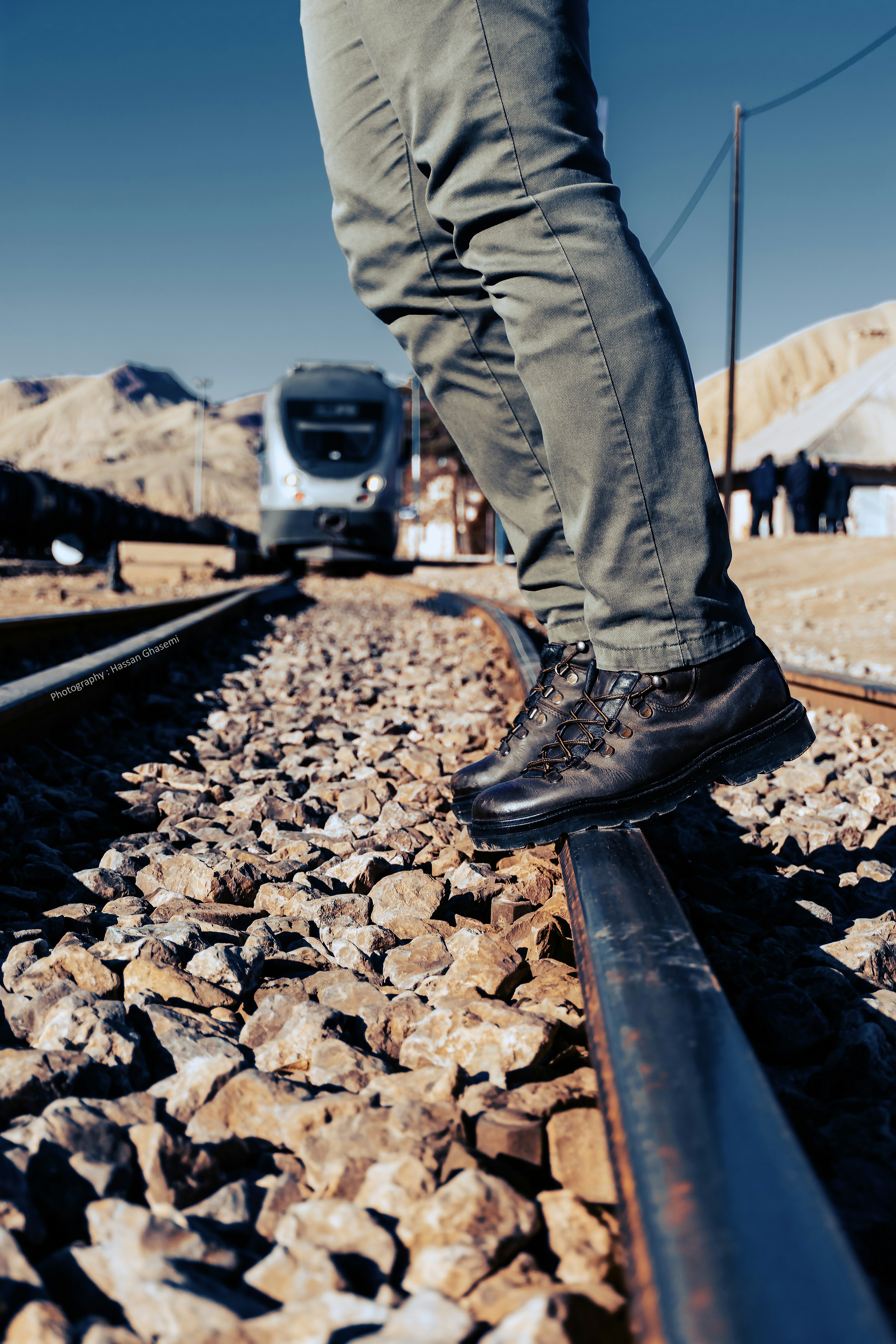 a person standing on a train track next to a train