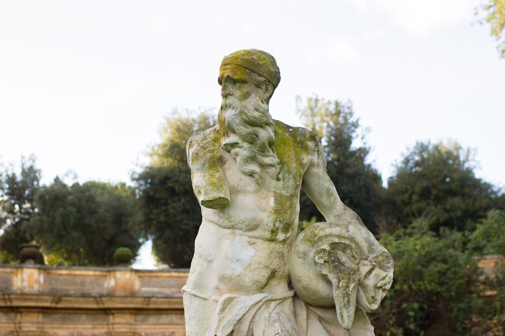 a statue of a man holding a bowl