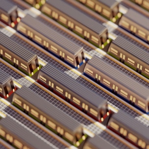 Aerial view of a miniature model featuring multiple parallel train tracks with trains lined up on them. The scene includes intricate details such as train windows and track lines, suggesting a highly organized transportation system.