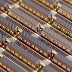 Aerial view of a miniature model featuring multiple parallel train tracks with trains lined up on them. The scene includes intricate details such as train windows and track lines, suggesting a highly organized transportation system.