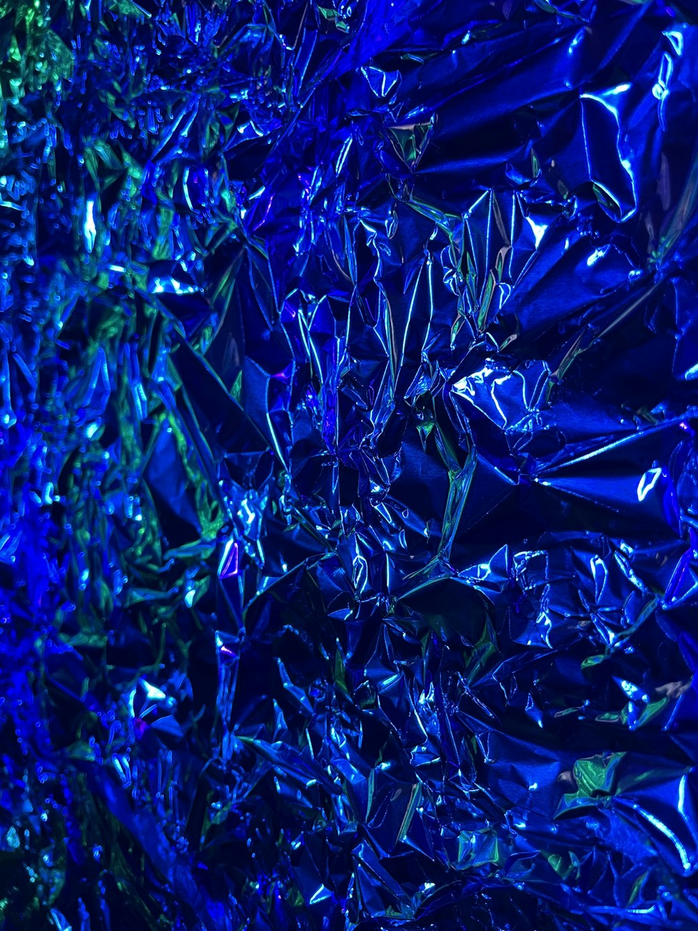 a close up of a shiny blue surface