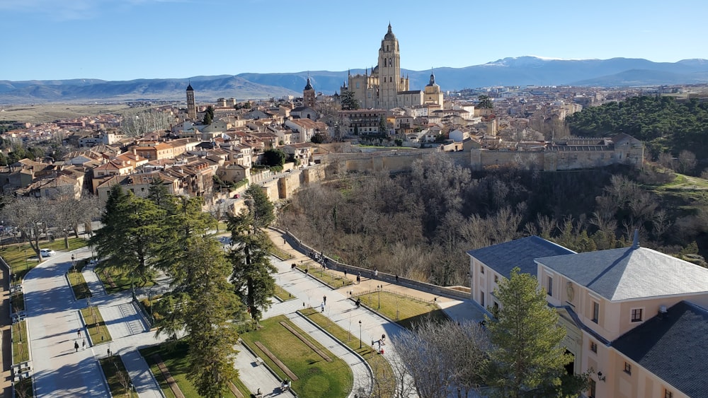 an aerial view of a city with mountains in the background