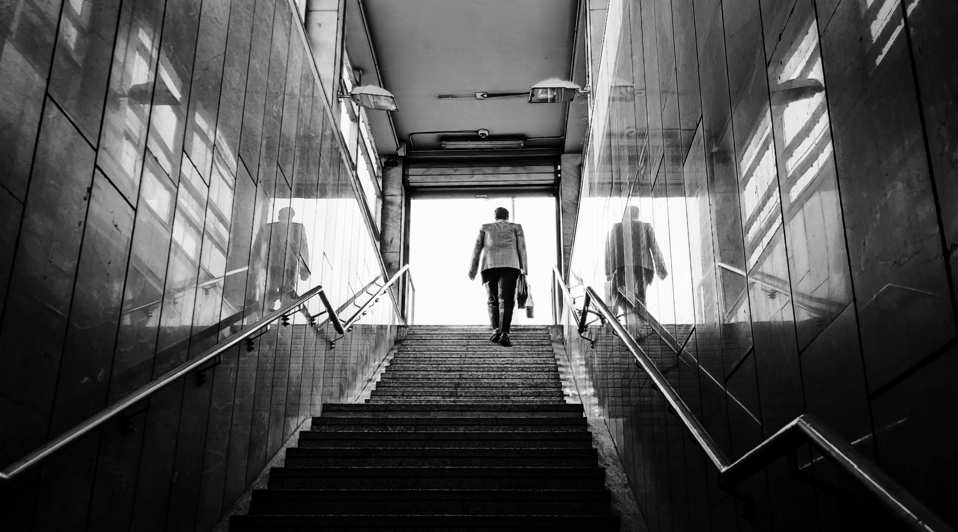 Man walking down stairs representing progress