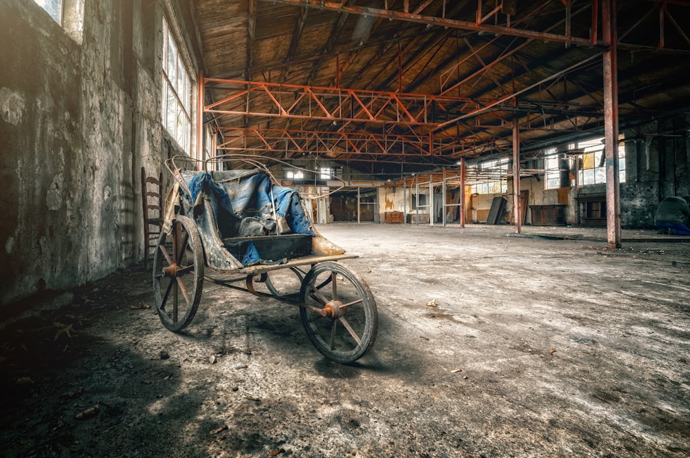 a horse drawn carriage in an old warehouse