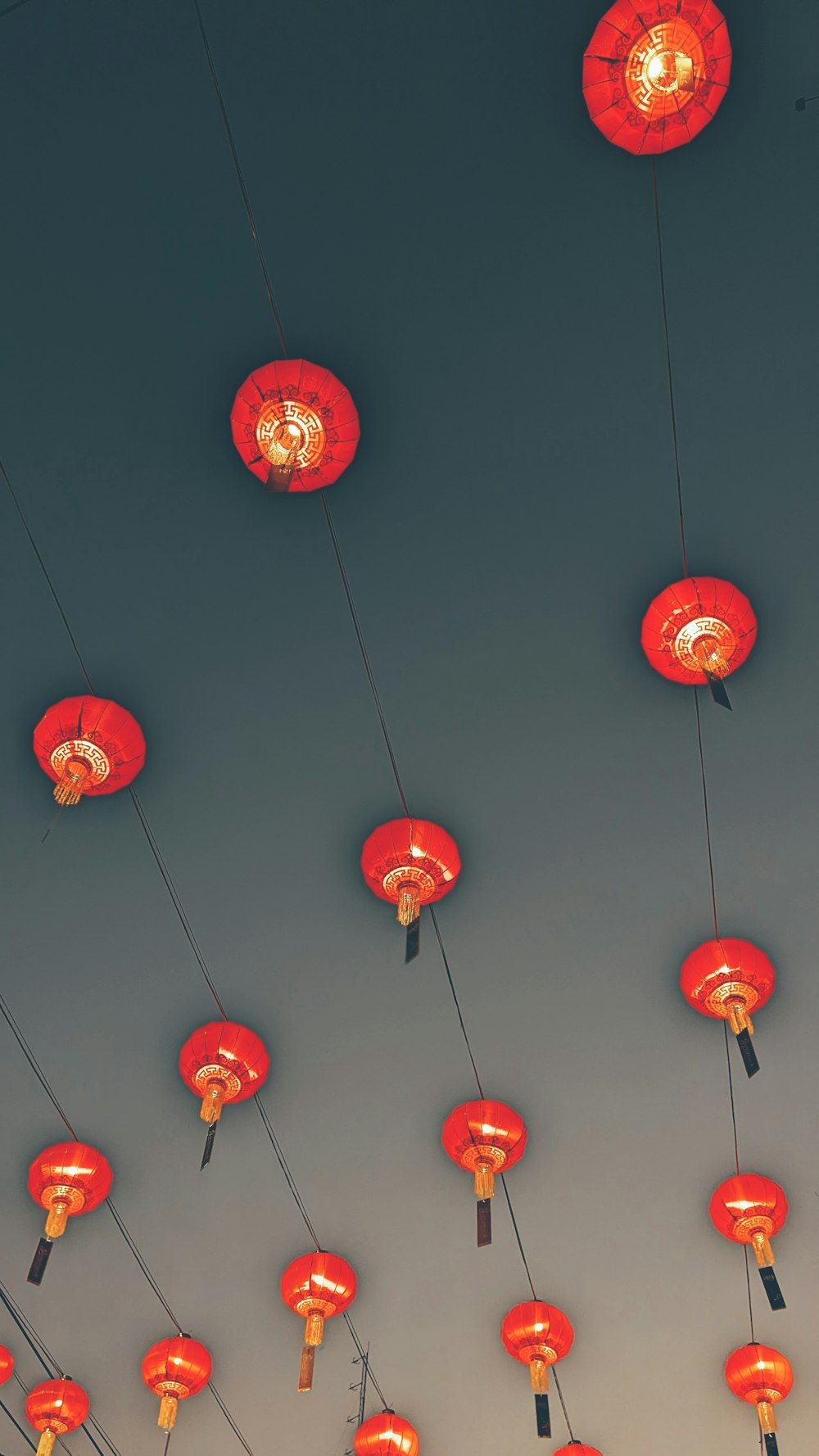 a group of red lanterns hanging from wires